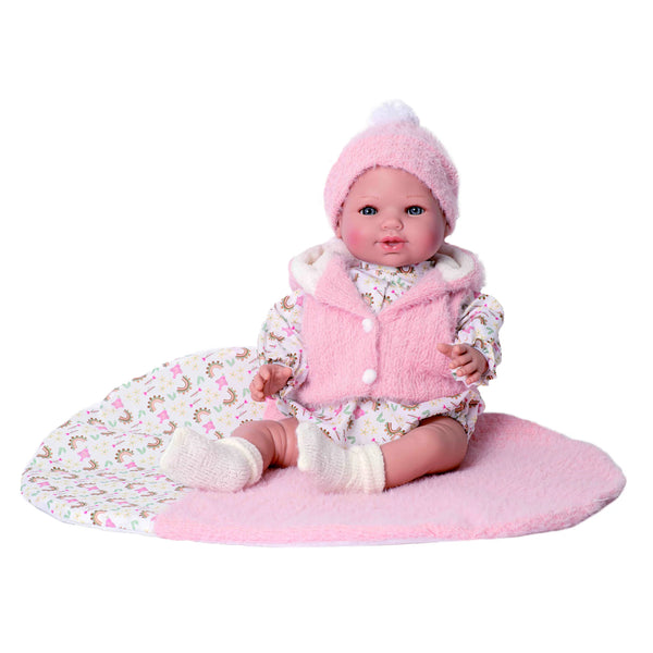Bebé María con peso de Rosatoys 4669, 46 cm, sentada con chaleco rosa de pelo, gorro de punto con pompón y pelele de arcoíris sobre su manta