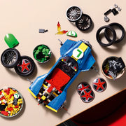 Vista cenital de piezas LEGO Super Mario 72050 Mario Kart en construcción: chasis azul del kart Mach 8 con boweles de ruedas, llamas naranjas, casco verde Luigi y discos estrella roja preparados