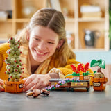 Chica adolescente sonriendo mientras juega con las plantas LEGO Harry Potter 76474 Herbología en mesa de salón - Mimbulus Mimbletonia, Geranios Colmilludos y Mandrágora