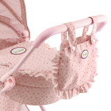 Detalle capazo cuco Olivia con volantes decorativos y bolso paseo rosa
