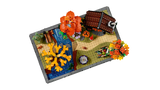 Jardín LEGO vista superior con cabaña marrón, estanque azul y árboles otoñales
