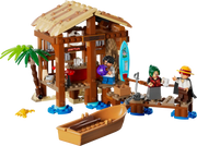 LEGO ONE PIECE set 75636 con caja del producto y cabaña construida mostrando Luffy, Shanks, Makino en escena de playa con bote pirata y embarcadero detallado
