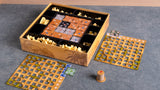 Caja abierta de Babylon junto a dos tableros personales con forma de cuadrícula