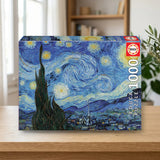 Educa Borrás Puzzle 1000 Noche Estrellada Vincent Van Gogh (19263) sobre una mesa de madera