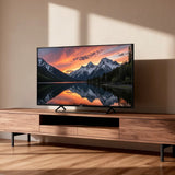 Televisor Genium GTV65QLED de 65 pulgadas colocado en un mueble de salón