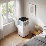 Aire acondicionado portátil Infiniton PACSF25A instalado en un dormitorio con tubo de salida por la ventana
